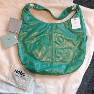 NWOT HOBO bag, green with redish orange patterned lining. Has manufactured tags